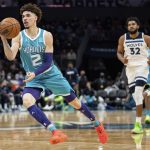 
              Charlotte Hornets guard LaMelo Ball (2) passes the ball during the first half of the team's NBA basketball game against the Minnesota Timberwolves in Charlotte, N.C., Friday, Nov. 26, 2021. (AP Photo/Jacob Kupferman)
            