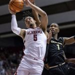 
              Alabama guard Jaden Shackelford (5) grabs a rebound with Oakland forward Jamal Cain (1) in pursuit during the second half of an NCAA college basketball game, Friday, Nov. 19, 2021, in Tuscaloosa, Ala. (AP Photo/Vasha Hunt)
            