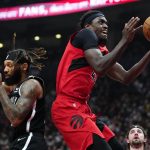 
              Toronto Raptors forward Pascal Siakam (43) goes to the net past Brooklyn Nets guard DeAndre' Bembry, left, during first-half NBA basketball game action in Toronto, Sunday, Nov. 7, 2021. (Frank Gunn/The Canadian Press via AP)
            