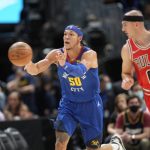 
              Denver Nuggets forward Aaron Gordon, left, passes the ball as Chicago Bulls guard Alex Caruso defends during the first half of an NBA basketball game Friday, Nov. 19, 2021, in Denver. (AP Photo/David Zalubowski)
            