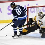 
              Pittsburgh Penguins goaltender Tristan Jarry (35) makes a save on Winnipeg Jets' Kyle Connor (81) during the third period of an NHL hockey game Monday, Nov. 22, 2021, in Winnipeg, Manitoba. (Fred Greenslade/The Canadian Press via AP)
            