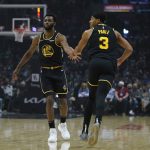 
              Golden State Warriors forward Andrew Wiggins (22) celebrates with guard Jordan Poole (3) after a point during the first half of an NBA basketball game against the Los Angeles Clippers in Los Angeles, Sunday, Nov. 28, 2021. (AP Photo/Ashley Landis)
            