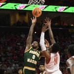 
              George Mason guard DeVon Cooper (0) goes to the basket against Maryland guard Xavier Green (11) during the first half of an NCAA college basketball game Wednesday, Nov. 17, 2021, in College Park, Md. (AP Photo/Nick Wass)
            