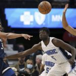 
              Minnesota Timberwolves' Karl-Anthony Towns (32) passes the ball against Orlando Magic's Mo Bamba (5) during the first half of an NBA basketball game Monday, Nov. 1, 2021, in Minneapolis. (AP Photo/Stacy Bengs)
            