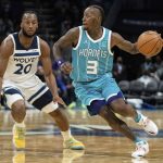 
              Charlotte Hornets guard Terry Rozier (3) brings the ball up while guarded by Minnesota Timberwolves forward Josh Okogie (20) during the first half of an NBA basketball game in Charlotte, N.C., Friday, Nov. 26, 2021. (AP Photo/Jacob Kupferman)
            