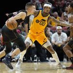 
              Miami Heat guard Tyler Herro, left, drives to the basket as Utah Jazz guard Jordan Clarkson (00) defends during the first half of an NBA basketball game, Saturday, Nov. 6, 2021, in Miami. (AP Photo/Lynne Sladky)
            