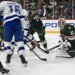 
              Minnesota Wild goalie Cam Talbot (33) stops a shot by Tampa Bay Lightning center Ross Colton, center left, as Wild left wing Kirill Kaprizov shoves Colton from behind during the second period of an NHL hockey game Sunday, Nov. 28, 2021, in St. Paul, Minn. (AP Photo/Craig Lassig)
            