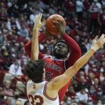
              St. John's Dylan Addae-Wusu (5) shoots over Indiana's Trey Galloway (32) during the first half of an NCAA college basketball game, Wednesday, Nov. 17, 2021, in Bloomington, Ind. (AP Photo/Darron Cummings)
            