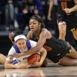 
              James Madison guard Madison Green, left, and Maryland forward Angel Reese, right, dive on the ball during the second half of an NCAA basketball game in Harrisonburg, Va., Sunday, Nov. 14, 2021. (Daniel Lin/Daily News-Record Via AP)
            