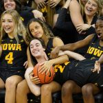 
              Iowa guard Caitlin Clark, center, laughs with teammates after having their formal team photo taken during Iowa's NCAA college basketball media day, Thursday, Oct. 28, 2021, in Iowa City, Iowa. Last season Clark put up the best numbers in the country as a freshman, was a consensus All-American and led Iowa deep into the NCAA tournament. Asked what she could do for an encore for the ninth-ranked Hawkeyes, Clark smiled and said, "I think just come back and be myself again." (AP Photo/Charlie Neibergall)
            
