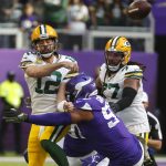 
              Green Bay Packers quarterback Aaron Rodgers (12) passes as he is hit by Minnesota Vikings defensive end Everson Griffen (97) during the first half of an NFL football game, Sunday, Nov. 21, 2021, in Minneapolis. (AP Photo/Bruce Kluckhohn)
            