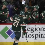 
              Minnesota Wild's Brandon Duhaime (21) high fives teammates on the bench after scoring a goal against the New York Islanders during the third period of an NHL hockey game Sunday, Nov. 7, 2021, in St. Paul, Minn. Minnesota won 5-2. (AP Photo/Stacy Bengs)
            