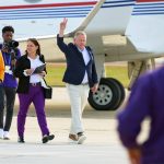 
              New LSU football coach Brian Kelly gestures to fans after his arrival at Baton Rouge Metropolitan Airport, Tuesday, Nov. 30, 2021, in Baton Rouge, La. Kelly, formerly of Notre Dame, is said to have agreed to a 10-year contract with LSU worth $95 million plus incentives.  (AP Photo/Matthew Hinton)
            
