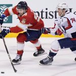 
              Florida Panthers center Maxim Mamin (98) and Washington Capitals defenseman John Carlson (74) battle for the puck during the first period of an NHL hockey game, Tuesday, Nov. 30, 2021, in Sunrise, Fla. (AP Photo/Wilfredo Lee)
            