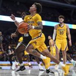 
              Minnesota guard Sean Sutherlin (24) is fouled by Jacksonville guard Gyasi Powell (10) on a drive to the basket during the second half of an NCAA college basketball game Wednesday, Nov. 24, 2021, in Minneapolis. (Aaron Lavinsky/Star Tribune via AP)
            
