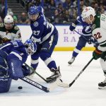 
              Tampa Bay Lightning goaltender Brian Elliott (1) dives on a shot by Minnesota Wild left wing Kevin Fiala (22) during the first period of an NHL hockey game Sunday, Nov. 21, 2021, in Tampa, Fla. Looking on are Wild right wing Mats Zuccarello (36) and Lightning's Ryan McDonagh (27). (AP Photo/Chris O'Meara)
            