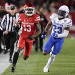 
              Houston wide receiver Jeremy Singleton (13) runs past Memphis linebacker JJ Russell (23) after his reception during the first half of an NCAA college football game, Friday, Nov. 19, 2021, in Houston. (AP Photo/Eric Christian Smith)
            
