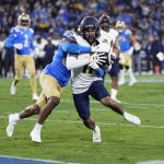 
              UCLA defensive back Quentin Lake, left, stops California wide receiver Kekoa Crawford short of the end zone during the first half of an NCAA college football game Saturday, Nov. 27, 2021, in Pasadena, Calif. (AP Photo/Jae C. Hong)
            