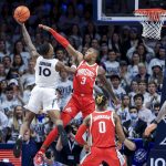 
              Xavier's Nate Johnson drives to the basket against Ohio State's Eugene Brown III (3) during the first half of an NCAA college basketball game, Thursday, Nov. 18, 2021, in Cincinnati. (AP Photo/Aaron Doster)
            
