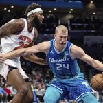 
              Charlotte Hornets center Mason Plumlee (24) shields the ball from New York Knicks center Mitchell Robinson (23) during the first half of an NBA basketball game in Charlotte, N.C., Friday, Nov. 12, 2021. (AP Photo/Jacob Kupferman)
            