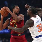 
              New York Knicks forward Julius Randle (30) defends against Cleveland Cavaliers center Evan Mobley (4) during the first half of an NBA basketball game in New York, Sunday, Nov. 7, 2021. (AP Photo/Noah K. Murray)
            