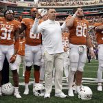 
              Texas head coach Steve Sarkisian, center, stands with his team as they sing "The Eyes Of Texas" after defeating Kansas State 22-17 in an NCAA college football game in Austin, Texas, Friday, Nov. 26, 2021. (AP Photo/Chuck Burton)
            