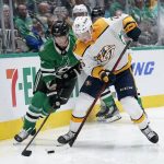 
              Dallas Stars' John Klingberg (3) and Nashville Predators' Philip Tomasino (26) compete for control of the puck in the second period of an NHL hockey game in Dallas, Wednesday, Nov. 10, 2021. (AP Photo/Tony Gutierrez)
            
