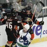
              Anaheim Ducks' Sonny Milano, upper right, celebrates his goal with Trevor Zegras (46) as Vancouver Canucks' Conor Garland, foreground, skates past them during the second period of an NHL hockey game Sunday, Nov. 14, 2021, in Anaheim , Calif. (AP Photo/Jae C. Hong)
            