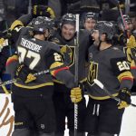 
              The Vegas Golden Knights celebrate defenseman Brayden McNabb's (hidden) goal against the Vancouver Canucks during the second period of an NHL hockey game Saturday, Nov. 13, 2021, in Las Vegas. (AP Photo/David Becker)
            