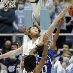 
              North Carolina forward Brady Manek (45) blocks North Carolina Asheville guard Trent Stephney (0) during the first half of an NCAA college basketball game in Chapel Hill, N.C., Tuesday, Nov. 23, 2021. (AP Photo/Gerry Broome)
            
