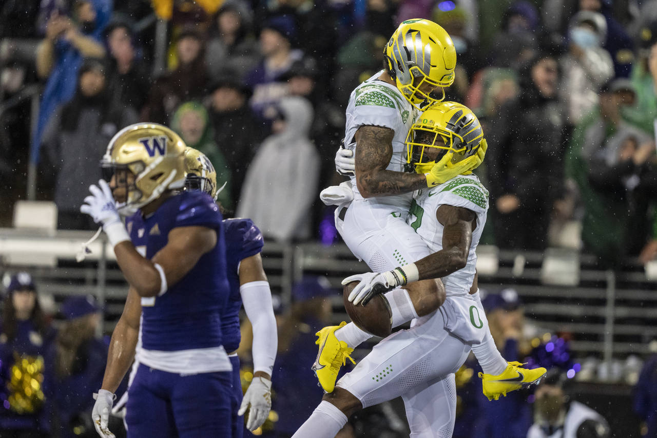 Oregon wide receiver Mycah Pittman, left, and wide receiver Devon Williams, right, celebrate a touc...