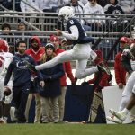 
              Penn State quarterback Christian Veilleux (9) goes airborne on a keeper while trying to elude Rutgers defenders Tyshon Fogg (8) and Max Melton (16) during an NCAA college football game in State College, Pa., Saturday, Nov. 20, 2021. Penn State shut out Rutgers 28-0.(AP Photo/Barry Reeger)
            