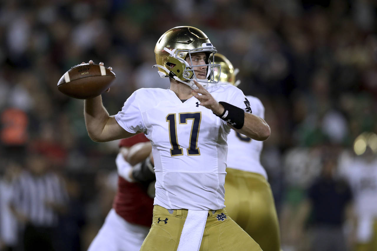 Notre Dame quarterback Jack Coan prepares to throw a pass against Stanford during the first half of...