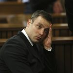 
              FILE — Oscar Pistorius, gestures, at the end of the fourth day of sentencing proceedings in the high court in Pretoria, South Africa, Thursday, Oct. 16, 2014. Eight years after he shot dead his girlfriend, Pistorius is up for parole, but first he must meet with her parents as part of the parole procedure. A parole hearing for Pistorius was scheduled for last month and then canceled, partly because a meeting between Pistorius and Steenkamp's parents, Barry and June, had not been arranged, lawyers for both parties told The Associated Press on Monday, Nov. 8, 2021. (AP Photo/Alon Skuy, Pool. File)
            
