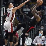 
              Los Angeles Clippers guard Eric Bledsoe, right, shoots over Miami Heat guard Tyler Herro (14) during the first half of an NBA basketball game Thursday, Nov. 11, 2021, in Los Angeles. (AP Photo/Marcio Jose Sanchez)
            