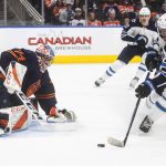 
              Winnipeg Jets' Andrew Copp (9) is stopped by Edmonton Oilers goalie Stuart Skinner (74) during first period NHL hockey action in Edmonton, Alberta, on Thursday, Nov. 18, 2021. (Jason Franson/The Canadian Press via AP)
            