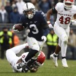 
              Penn State wide receiver Parker Washington (3) breaks a tackle by Rutgers defensive back Christian Izien (0) during an NCAA college football game in State College, Pa., Saturday, Nov. 20, 2021. Penn State shut out Rutgers 28-0. (AP Photo/Barry Reeger)
            