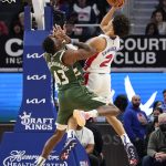
              Detroit Pistons guard Cade Cunningham (2) attempts a shot as Milwaukee Bucks forward Thanasis Antetokounmpo (43) defends during the first half of an NBA basketball game, Tuesday, Nov. 2, 2021, in Detroit. (AP Photo/Carlos Osorio)
            