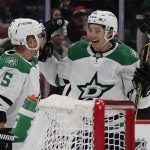 
              Dallas Stars' Andrej Sekera (5) celebrates with Jason Robertson (21) after Robertson's goal against the Arizona Coyotes during the second period of an NHL hockey game Saturday, Nov. 27, 2021, in Glendale, Ariz. (AP Photo/Darryl Webb)
            