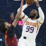 
              Phoenix Suns' Jae Crowder (99) shoots over Cleveland Cavaliers' Darius Garland (10) during the first half of an NBA basketball game Wednesday, Nov. 24, 2021, in Cleveland. (AP Photo/Tony Dejak)
            