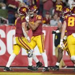 
              Southern California quarterback Jaxson Dart, left, celebrates with wide receiver Kyle Ford (81) after running to the end zone for a touchdown during the first half of an NCAA college football game against Brigham Young in Los Angeles, Saturday, Nov. 27, 2021. (AP Photo/Ashley Landis)
            