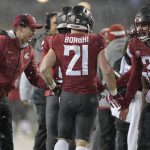 
              Washington State acting head coach Jake Dickert, left, and defensive back defensive back Simon Samarzich (34) greet running back Max Borghi (21) after Borghi scored a touchdown during the first half of an NCAA college football game against Arizona, Friday, Nov. 19, 2021, in Pullman, Wash. (AP Photo/Ted S. Warren)
            