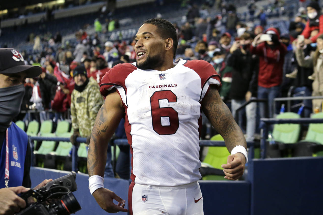 Arizona Cardinals' James Conner smiles as he heads off the field after his team defeated the Seattl...