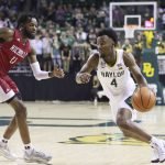
              Baylor guard LJ Cryer (4) drives against Nicholls State guard Latrell Jones (11) in the second half of an NCAA college basketball game, Monday, Nov. 15, 2021, in Waco, Texas. (AP Photo/Rod Aydelotte)
            
