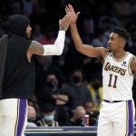 
              Los Angeles Lakers forward Carmelo Anthony, left, celebrates with guard Malik Monk during the second half of an NBA basketball game against the Detroit Pistons Sunday, Nov. 28, 2021, in Los Angeles. (AP Photo/Alex Gallardo)
            