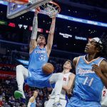 
              Los Angeles Clippers center Isaiah Hartenstein (55) dunks against the Detroit Pistons during the second half of an NBA basketball game Friday, Nov. 26, 2021, in Los Angeles. The Clippers won 107-96. (AP Photo/Ringo H.W. Chiu)
            