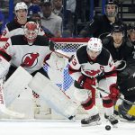 
              New Jersey Devils center Nico Hischier (13) intercepts a pass intended for Tampa Bay Lightning center Brayden Point (21) in front of goaltender Mackenzie Blackwood (29) during the first period of an NHL hockey game Saturday, Nov. 20, 2021, in Tampa, Fla. (AP Photo/Chris O'Meara)
            