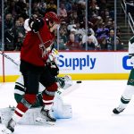 
              Arizona Coyotes left wing Loui Eriksson, front left, tries to redirect the puck in front of Minnesota Wild goaltender Kaapo Kahkonen as Wild defenseman Jon Merrill, right, watches during the first period of an NHL hockey game Wednesday, Nov. 10, 2021, in Glendale, Ariz. (AP Photo/Ross D. Franklin)
            