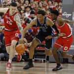 
              Ohio State's Kyle Young, left, and  Jamari Wheeler, right, and Duke's Wendell Moore chase a loose ball during the first half of an NCAA college basketball game Tuesday, Nov. 30, 2021, in Columbus, Ohio. (AP Photo/Jay LaPrete)
            