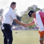 
              Jason Kokrak, left, shakes hands with his caddie David Robinson, right, after sinking the last putt on the 18th green to win the Houston Open golf tournament with ten under par Sunday, Nov. 14, 2021, in Houston. (AP Photo/Michael Wyke)
            